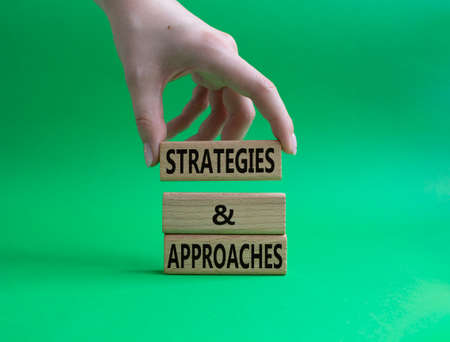 Flexible and agile symbol. Concept word Flexible and agile on wooden blocks. Beautiful green background. Businessman hand. Business and Flexible and agile concept. Copy spaceの写真素材