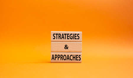 Flexible and agile symbol. Concept word Flexible and agile on wooden blocks. Beautiful orange background. Business and Flexible and agile concept. Copy spaceの写真素材