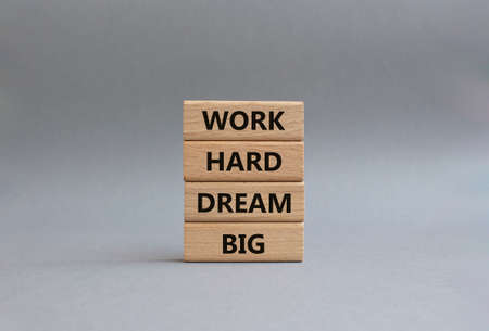 Work and dream symbol. Wooden blocks with words 'Work Hard Dream Big'. Beautiful grey background. Business and Work Hard Dream Big concept. Copy space.の写真素材