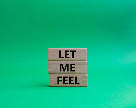Feel symbol. Wooden blocks with words 'Let me feel'. Beautiful green background. Psychology and let me feel concept. Copy space.の写真素材