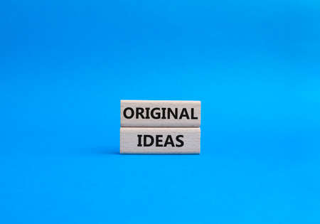Original ideas. Concept word Original ideas on wooden cubes. Beautiful blue background. Business and Original ideas concept. Copy space.の写真素材