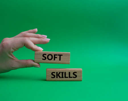 Soft skills symbol. Wooden blocks with words Soft skills. Beautiful green background. Businessman hand. Business and Soft skills concept. Copy space.の写真素材