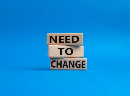 Need to change symbol. Concept words 'Need to change' on wooden blocks. Beautiful blue background. Business and Need to change concept. Copy space.の写真素材