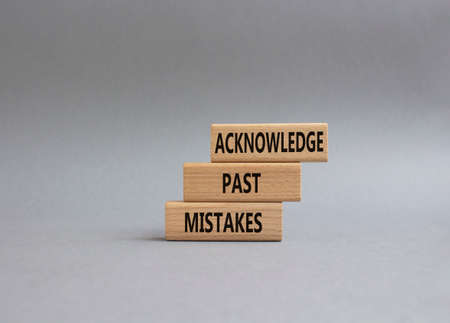 Acknowledge Past Mistakes symbol. Wooden blocks with words Acknowledge Past Mistakes. Beautiful grey background. Business and Acknowledge Past Mistakes. Copy space.の写真素材