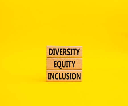 Diversity Equity Inclusion symbol. Concept words Diversity Equity Inclusion on wooden blocks. Beautiful yellow background. Business and Diversity Equity Inclusion concept. Copy spaceの写真素材