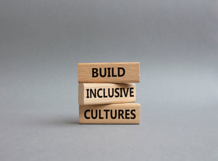 Build Inclusive Cultures symbol. Wooden blocks with words Build Inclusive Cultures. Beautiful grey background. Business and Build Inclusive Cultures. Copy space.の写真素材