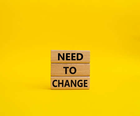 Need to change symbol. Concept words 'Need to change' on wooden blocks. Beautiful yellow background. Business and Need to change concept. Copy space.の写真素材