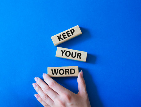 Keep your word symbol. Wooden blocks with words beautiful blue background. businessman hand. Business and Keep your word concept. copyspace.の写真素材