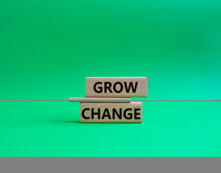 Grow and change symbol. Concept word Grow and Change on wooden blocks. beautiful green background. Business and Grow and Change concept. copy spaceの写真素材