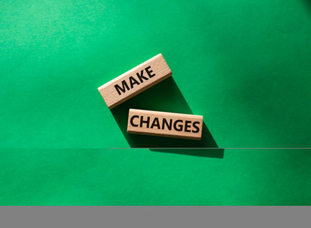 Make changes symbol. Wooden blocks with words Make changes. beautiful green background. Business and Make changes concept. copyspace.の写真素材