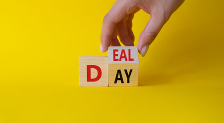 Deal of the Day symbol. Businessman hand Turnes cube and changes word Day to Deal. beautiful yellow...