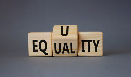 Equity and Equality symbol. Turned wooden cubes with words Equality and Equity. Beautiful gray background. Equity and Equality and business concept. copy spaceの写真素材