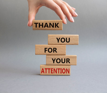 Attention symbol. Wooden blocks with words Thank you for your attention. Beautiful gray background. businessman hand. Business and Thank you for your attention concept. copyspace.の写真素材