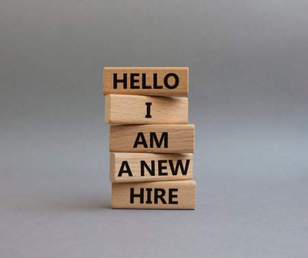 Hello I am a new hire symbol. Concept words Hello I am a new hire on wooden blocks. Beautiful gray background. Business and Hello I am a new hire concept. copyspace.の写真素材