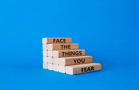 Face the things you fear symbol. Wooden blocks with words Face the things you fear. beautiful blue background. Business and Face the things you fear concept. copyspace.の写真素材