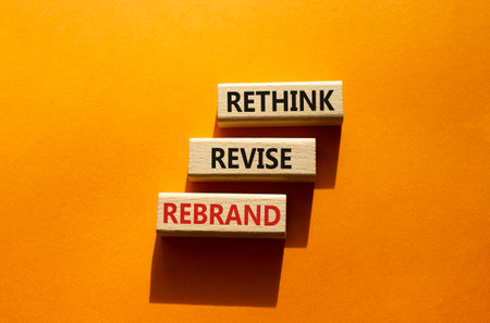 Rethink Revise Rebrand symbol. Wooden blocks with words Rethink Revise Rebrand. beautiful orange background. Business and Rethink Revise Rebrand concept. copyspace.の写真素材