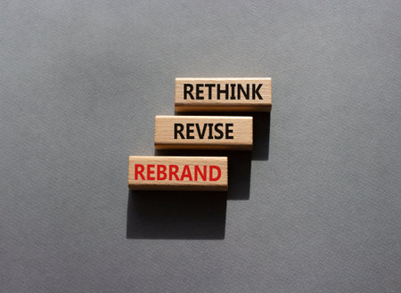 Rethink Revise Rebrand symbol. Wooden blocks with words Rethink Revise Rebrand. Beautiful gray background. Business and Rethink Revise Rebrand concept. copyspace.の写真素材