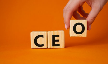 CEO - hief executive officer symbol. Concept word CEO on wooden cubes. businessman hand. Beautiful orange background. Business and CEO concept. copyspace.の写真素材