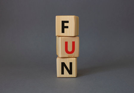 FUN symbol. Wooden cubes with word FUN. Beautiful gray background. FUN concept. copyspace.の写真素材