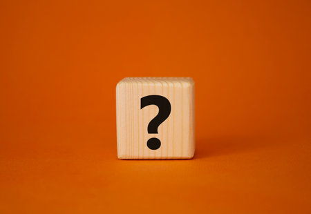 question mark symbol. Concept words question mark on wooden cube. Beautiful orange background. business and question marks. copyspace.の写真素材