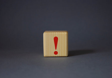 Exclamation mark symbol. Exclamation mark on wooden cubes. Beautiful gray background. Business and Exclamation mark concept. copyspace.の写真素材