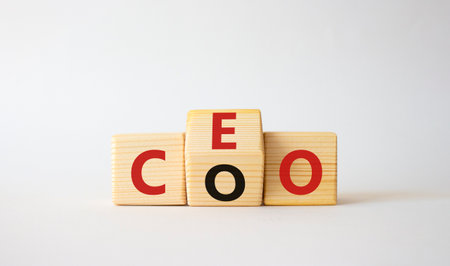 CEO and COO symbol. Turned wooden cubes with words CEO and COO. Beautiful white background. CEO and COO and business concept. copy spaceの写真素材