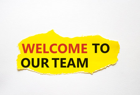 Welcome to our team symbol. Concept words Welcome to our team on torn yellow paper. Beautiful white background. Business and welcome to our team concept. copyspace.の写真素材