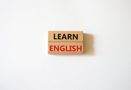 Learn English symbol. Wooden blocks with words Learn English. Beautiful white background. Business and Learn English concept. copyspace.の写真素材
