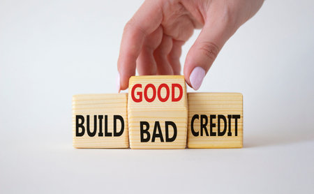 Build Good or Bad Credit symbol. Businessman hand turns wooden cubes and changes the words Build Bad...