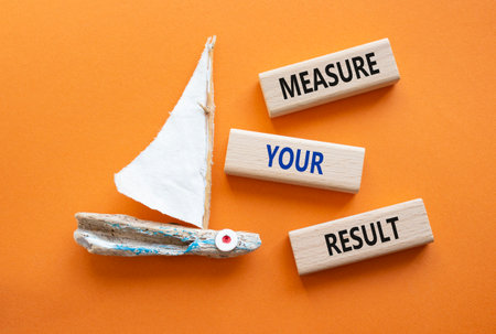 Measure your Result symbol. Concept words Measure your Result on wooden blocks. Beautiful orange background with boat. Business and Measure your Result concept. copyspace.の写真素材