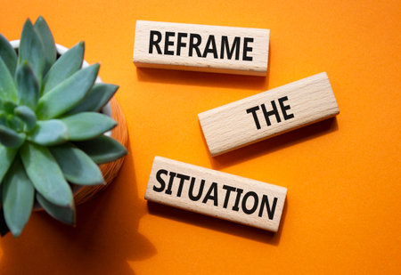Reframe the situation symbol. Concept words Reframe the situation on wooden blocks. Beautiful orange background with succulent plant. Business concept. Copy space.の写真素材
