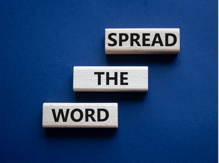 Spread the Word symbol. Concept wordsSpread the Word on wooden blocks. Beautiful deep blue background. Business and Spread the Word concept. Copy space.の写真素材