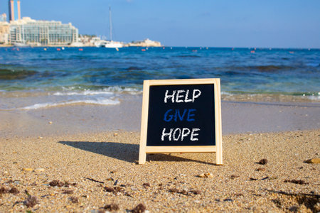 Help Give Hope symbol. Concept words Help Give Hope on chalk blackboard. Beautiful sea background. Business and Help Give Hope concept. Copy space.の写真素材