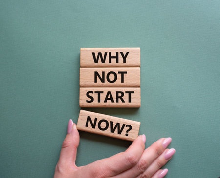 Why not start now symbol. Concept words Why not start now on wooden blocks. Beautiful gray green background. Businessman hand. Business and Why not start now concept. Copy space.の写真素材