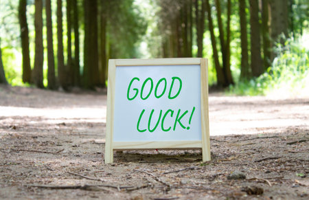 Good luck symbol. Good luck white chalk blackboard. Beautiful forest background. Business and Good luck concept. Copy space.の写真素材