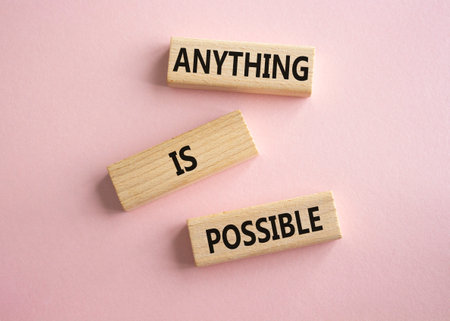 Anything is Possible symbol. Wooden blocks with words Anything is Possible. Beautiful pink background. Business and Anything is Possible concept. Copy space.の写真素材