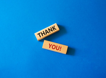 Thank you symbol. Wooden blocks with words Thank you. Beautiful blue background. Business and Thank you concept. Copy space.の写真素材