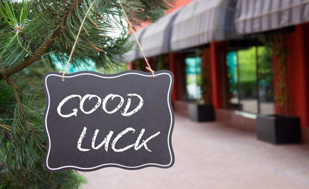 Good luck symbol. Good luck black chalk blackboard. Beautiful background with shop and tree. Business and Good luck concept. Copy space.の写真素材