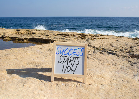 Success Starts Now symbol. Concept words Success Starts Now on white chalk blackboard. Beautiful sea background. Psychological social and Success Starts Now concept. Copy space.の写真素材