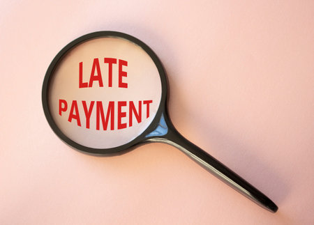 Late payment symbol. Concept word Late payment on magnifying glass. Beautiful pink background....
