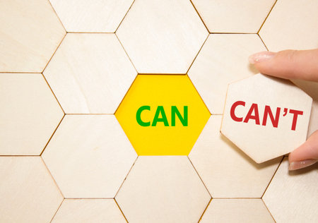 Can or Cant symbol. Concept word Can or Cant on wooden puzzle. Businessman hand. Beautiful yellow...