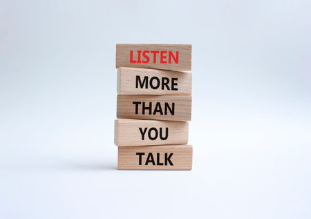 Listening skills symbol. Concept words Listen more than you Talk on wooden blocks. Beautiful white background. Business and Listen more than you Talk concept. Copy spaceの写真素材