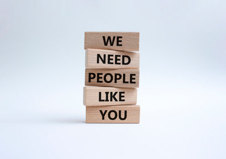 Hiring symbol. Wooden blocks with words We need People like You. Beautiful white background. Business and Hiring concept. Copy space.の写真素材