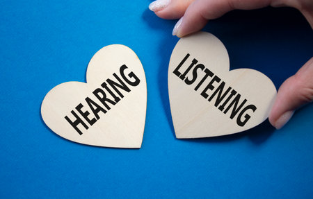 Growth and Stability symbol. Concept word Growth and Stability on wooden hearts. Businessman hand. Beautiful blue background. Copy spaceの写真素材