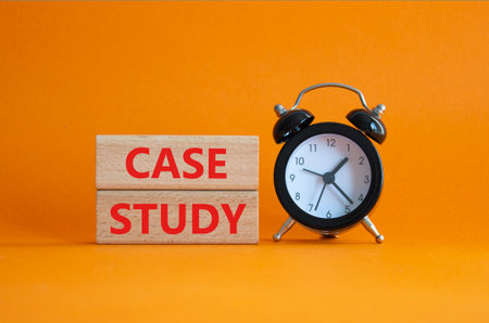 Case Study symbol. Wooden blocks with words Case Study. Beautiful orange background with alarm clock. Business and Case Study concept. Copy space.の写真素材