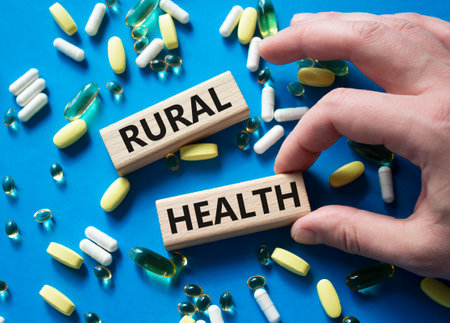Rural Health symbol. Concept word Rural Health on wooden blocks. Beautiful blue background with pills. Doctor Hand. Medicine and Rural Health concept. Copy spaceの写真素材