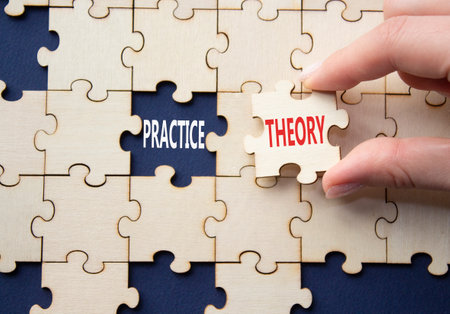 Theory or practice symbol. Concept word Theory or Practice on wooden puzzle. Businessman hand. Beautiful deep blue background. Business and Theory or Practice concept. Copy spaceの写真素材