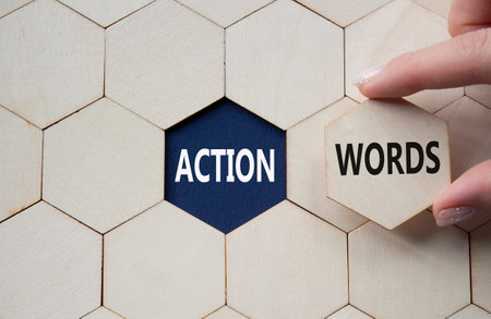 Action or words symbol. Concept word Action or words on wooden comb puzzle. Businessman hand. Beautiful deep blue background. Business and Action or words concept. Copy spaceの写真素材