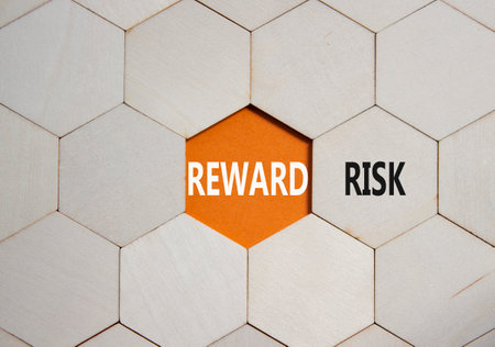 Risk or Reward symbol. Concept word Risk or Reward on wooden comb puzzle. Beautiful orange background. Business and Risk or Reward concept. Copy spaceの写真素材