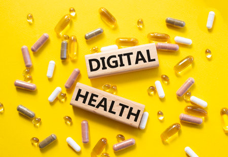 Digital Health symbol. Concept word Digital Health on wooden blocks. Beautiful yellow background with pills. Medicine and Digital Health concept. Copy spaceの写真素材